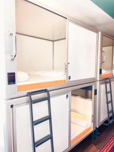 a room with bunk beds and a ladder at Copenhagen Downtown Hostel in Copenhagen