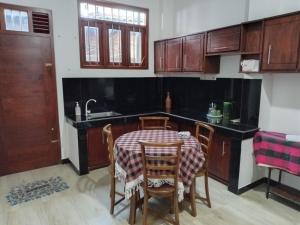 a kitchen with a table and chairs and a sink at The Grand Villa Malabe in Malabe
