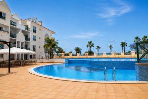 a swimming pool in front of a building at Grand Muthu Forte do Vale in Albufeira