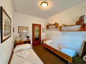 a room with two beds and a couch in it at 1Dest - Garda Vintage in Arco