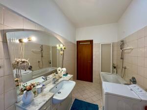 a bathroom with two sinks and a tub and a mirror at 1Dest - Garda Vintage in Arco +30 photos