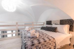 a bedroom with a bed with two towels on it at Rondinelle by Palazzo Refolo in Martano