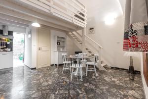 a dining room with a table and chairs and a staircase at Rondinelle by Palazzo Refolo in Martano +14 photos