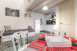 a living room with a bed and a kitchen at Rondinelle by Palazzo Refolo in Martano