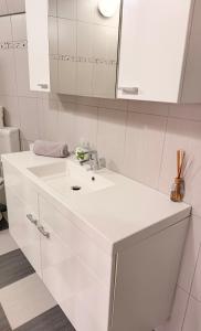 a white bathroom with a sink and a mirror at Villa Kraker in Muta
