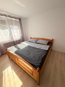 a bedroom with a wooden bed in a room at Villa Kraker in Muta
