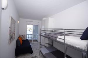 a bedroom with a bunk bed and a balcony at Teresita 2 in Empuriabrava +64 photos