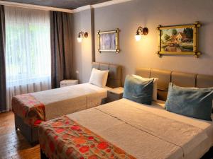 a hotel room with two beds and a window at City Park Suites City Center Corlu in Çorlu +46 photos