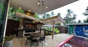 a patio with a table and chairs and a bar at Villa with the red pool in Hinkong
