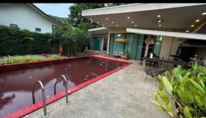 a swimming pool in the backyard of a house at Villa with the red pool in Hinkong