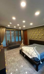 a bedroom with a bed and a couch at Villa with the red pool in Hinkong +7 photos