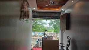 an open door to a room with a window at Hotel Trilok in Ujjain