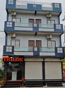 a building with balconies on the side of it at Hotel Trilok in Ujjain