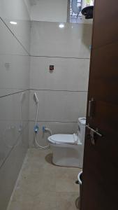 a bathroom with a shower and a toilet at Hotel Trilok in Ujjain +6 photos