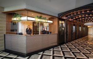 a restaurant with a counter with two people in the window at Grand Hotel Valies in Roermond +39 photos