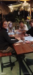 a group of people sitting at a wooden table at Gotrika Valley Gesst in Ella