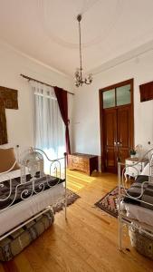a room with two beds in it with a window at Casa D'avó Souzinha in Ermidas +1 photo