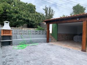 a house with a green hose on a patio at R2R - Casa Los Abuelos - C19A02 in Gormazo