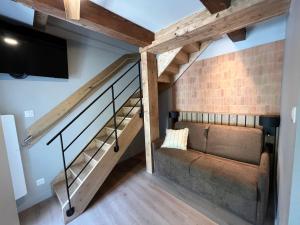 a living room with a couch and a flat screen tv at Hôtel Le Français in La Flotte