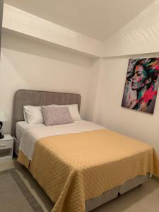 a bedroom with a bed and a painting on the wall at Lavanda in Budva