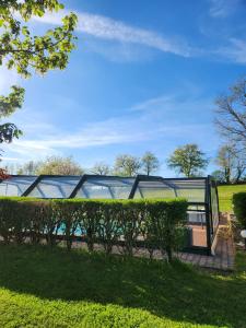 a bench in a park with green bushes at Les Vergnes in Saint-Pardoux-le-Neuf +169 photos