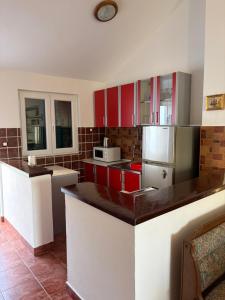 a kitchen with red and white cabinets and appliances at Lavanda in Budva +5 photos