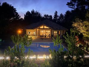 a house with a swimming pool at night at Pin Bleu in Moliets-et-Maa