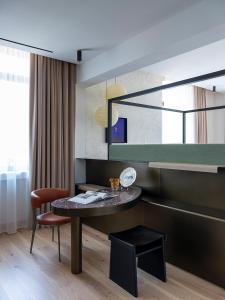 a living room with a table and a chair at Park Hotel in Desenzano del Garda