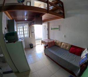 a living room with a couch and a loft at Chale Maresias 1 in São Sebastião