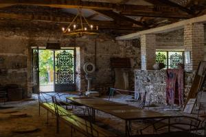 a room with two tables and chairs and windows at Chateau Eniseli in Eniseli