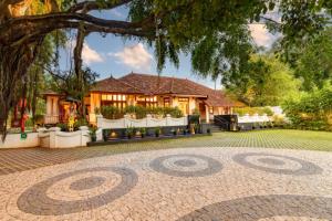 a house with a brick driveway in front of it at Amritha Heritage in Trivandrum