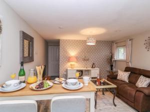 a living room with a table with food on it at Little Herriotts in Bristol