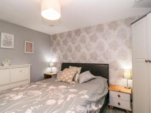 a bedroom with a bed with pink flowers on the wall at Little Herriotts in Bristol
