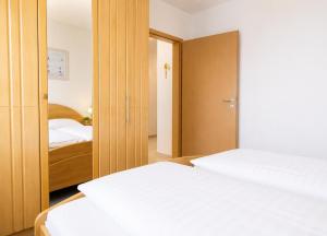 a bedroom with two beds and a closet at FeWo kleine Auszeit in Cuxhaven
