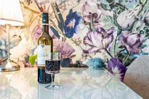 a bottle of wine sitting on a table next to a glass at Baden-Chalet - Wandergenuss in Bühl