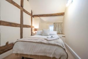 a bedroom with a bed with two towels on it at Kings Arms Hotel in Cleobury Mortimer