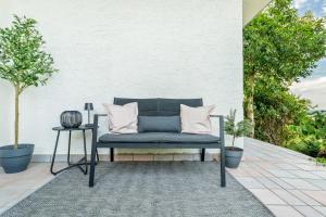 a blue bench with pillows on a patio at Baden-Chalet - Wandergenuss in Bühl
