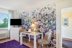a dining room with a floral wall mural at Baden-Chalet - Wandergenuss in Bühl