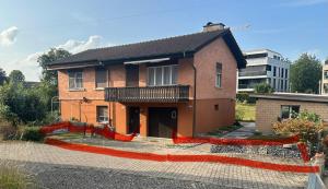 a brick house with a red line in front of it at Einfamilienhaus in Amriswil in Amriswil