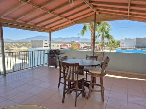 a patio with a table and chairs on a balcony at Bugambilias Terrazas in San Felipe