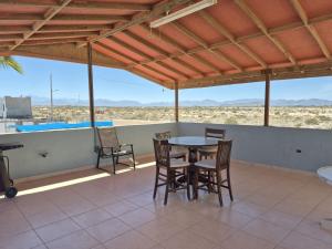 a table and chairs on a patio with a view of the desert at Bugambilias Terrazas in San Felipe