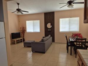 a living room with a couch and a table at Bugambilias Terrazas in San Felipe