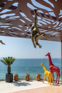a group of toy animals standing next to the ocean at Hotel Vlora Priam, Affiliated by Meliá in Vlorë +65 photos
