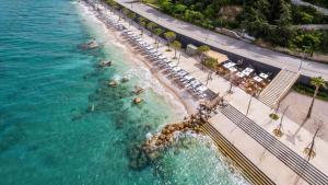 an aerial view of a beach with chairs and the ocean at Hotel Vlora Priam, Affiliated by Meliá in Vlorë