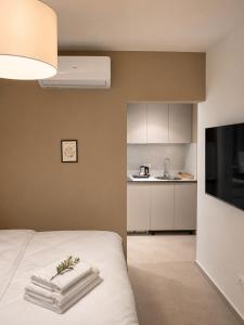 a bedroom with a bed with towels on it at White Arches in Ulcinj