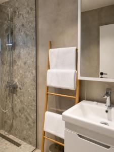 a bathroom with a sink and a shower and towels at White Arches in Ulcinj +63 photos