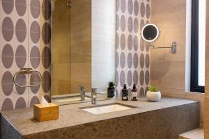 a bathroom with a sink and a mirror at INNSiDE by Meliá Mexico Roma Norte in Mexico City