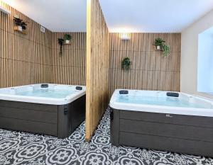 a bathroom with two large tubs in a room at Penzion Na bezu in Drahonice