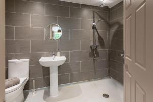a bathroom with a toilet and a sink and a shower at Saltkettle Sanctuary, Blakeney By Together Travel in Blakeney +18 photos