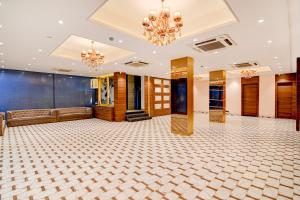 a large ballroom with a couch and a chandelier at Morya Villa - A Boutique Hotel in kolkata